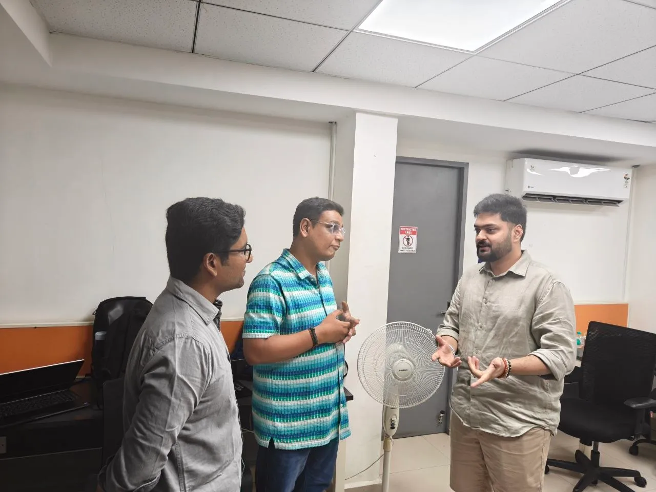 Three leaders in conversation at a meetup
