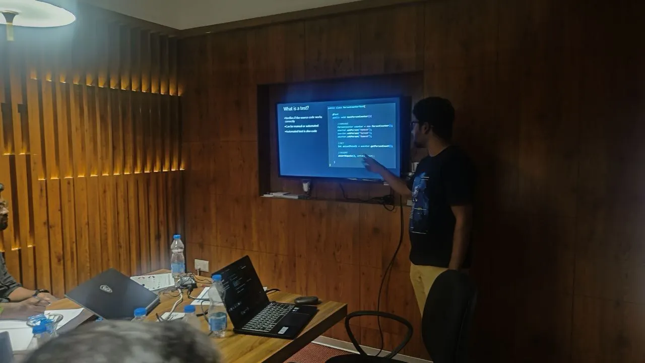 A speaker presenting in a workshop room